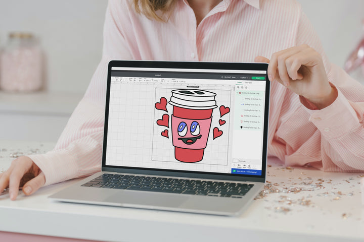 This is a video of a red to go coffee cup with a smiling face Design. Shown in a cutting machine software on the screen of a laptop, on a bag, on a t-shirt and on a card.